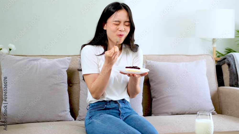 Happy woman enjoys its taste sitting down inside home living room, positive emotion. Happy woman enjoys its taste sitting down inside home living room, positive emotion.