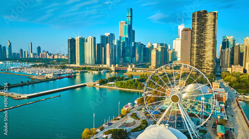 Tourism coast aerial Navy Pier Centennial Wheel sunrise with skyscrapers in Chicago, Lake Michigan photo