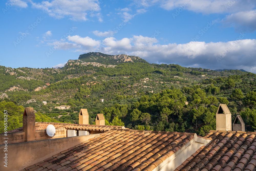 Stunning mountain views. Picturesque landscape with beautiful views in the sunlight, view through the roofs of houses.Mallorca Island, Spain, Balearic Islands