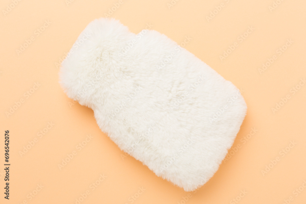 Fluffy water warmer bag on color background