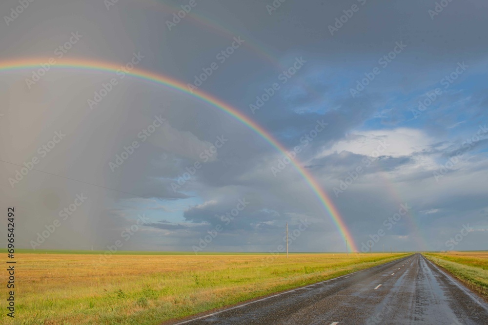 after the rain there is a beautiful rainbow in the steppe 