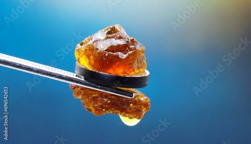 live rosin on a dab tool with a light blue background