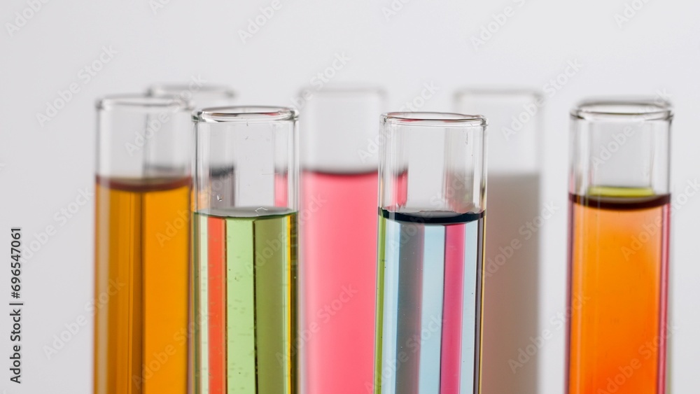 Close up shot of laboratory glassware on white background. Test tubes with colorful liquids in laboratory, scientific expertise. Close up shot of laboratory glassware on white background. Test tubes with colorful liquids in laboratory, scientific expertise.