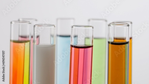 Close up shot of laboratory glassware on white background. Test tubes with colorful liquids in laboratory, scientific expertise.