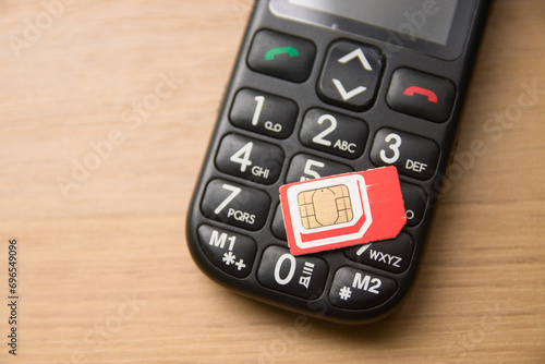 Prepaid card and old mobile phone with large keys for elderly users who do not use smartphones