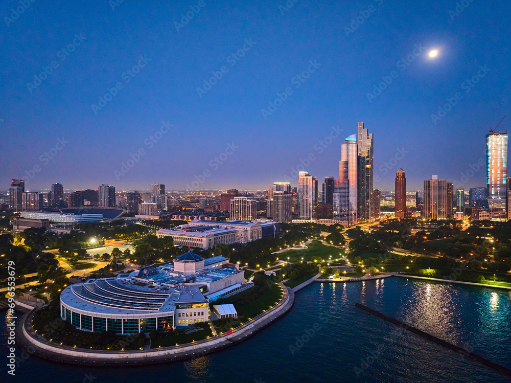 Naklejka premium Shedd Aquarium aerial Chicago with moon over city lights at night with harbor and Lake Michigan