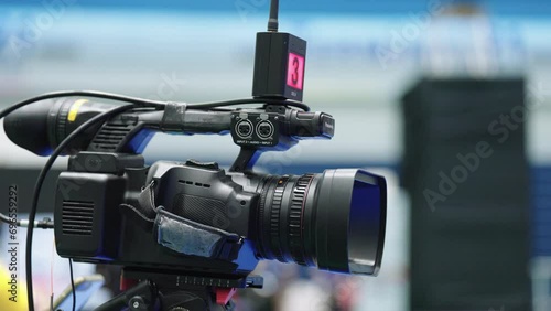 Professional camera with tripod recording Television Operator On TV broadcasting a live media event photo