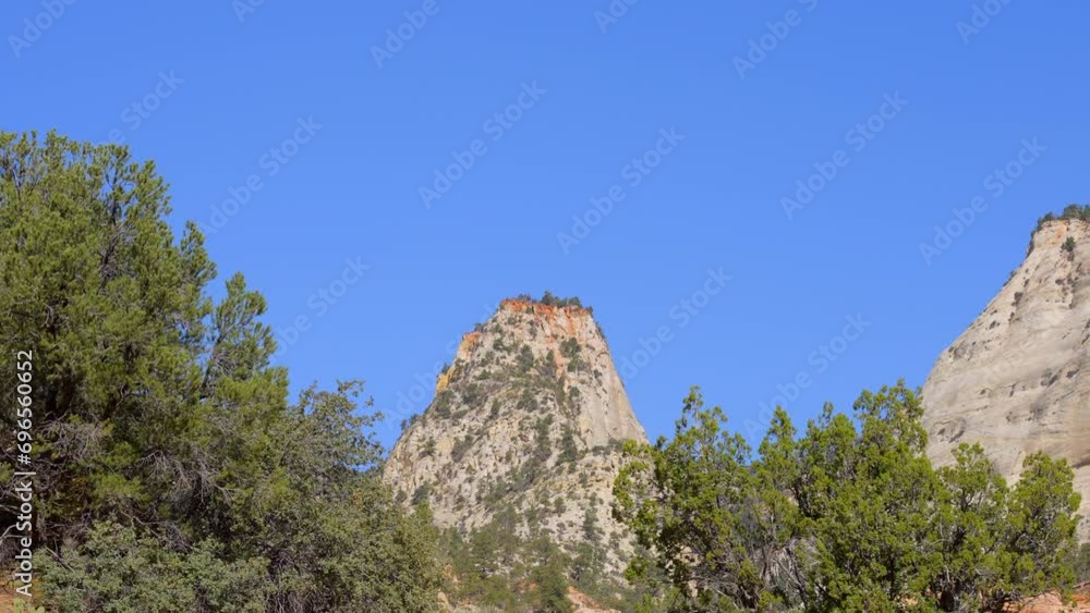 Establishing shot of mountains with red rocks in Zion Mount Carmel Highway, Zion National Park, Utah, North America. Day time. ProRes 422 HQ. Establishing shot of mountains with red rocks in Zion Mount Carmel Highway, Zion National Park, Utah, North America. Day time. ProRes 422 HQ.