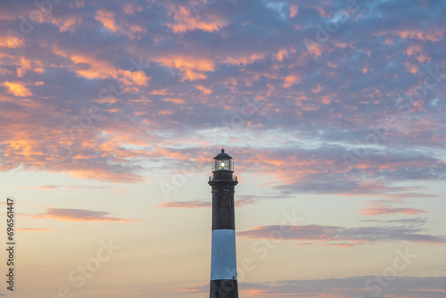 Fire Island Lighthouse sunset sky. Colorful cloudscape with vibrant clouds. Fire Island Lighthouse is located at Robert Moses State Park, Fire Island National Seashore, Long Island, New York