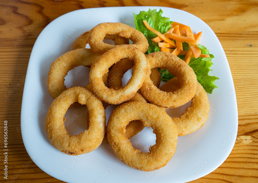 Fried squid served on a plate with vegetables