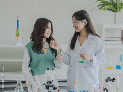 Portrait child kid girl asian young student tree people team group learning and smile have fun happy with science lab technology with in the classroom has a tubetest Microscope chemicals on table photo