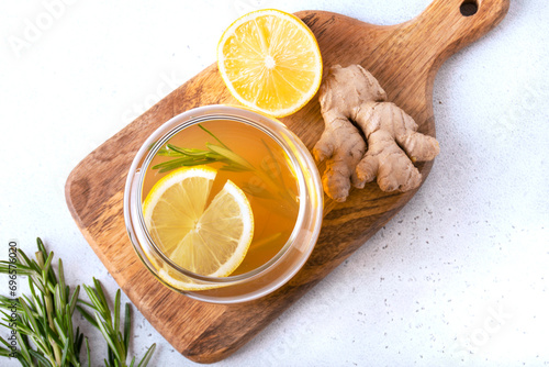 Ginger kombucha with lemon in a jar on a board, flat lay