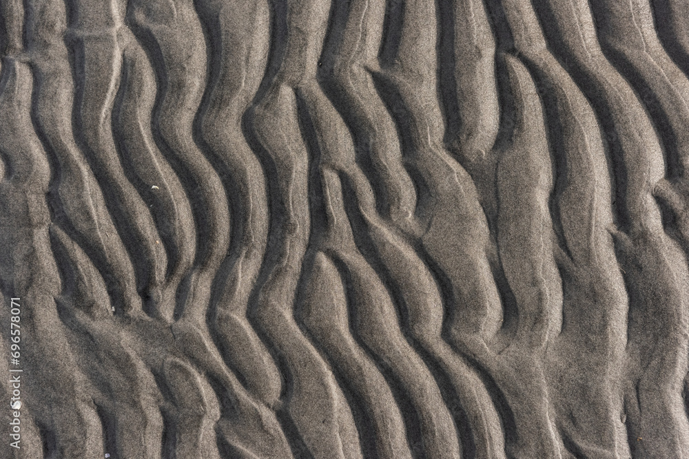 Wavy pattern of sand on a beach. Wavy pattern of sand on a beach.