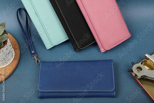 Women's leather wallets in different colors. Concept shot, top view. Custom background women's leather wallets view. Beautiful modern women's leather wallets