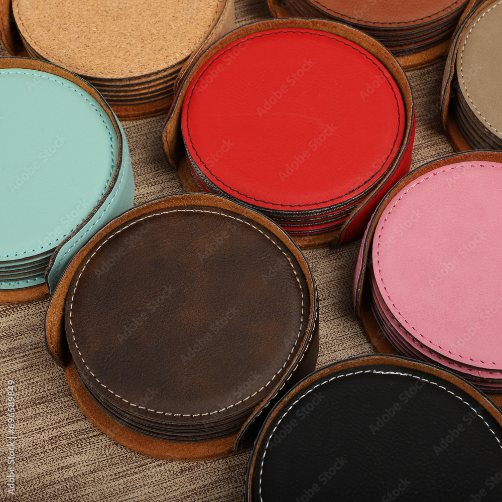 Leather table mats in different colors. Concept shot, top view. Custom background view of leather table coaster. Stitched and leather table coaster Leather table mats in different colors. Concept shot, top view. Custom background view of leather table coaster. Stitched and leather table coaster