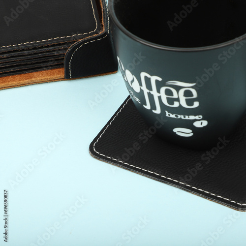 Leather table mats in different colors. Concept shot, top view. Custom background view of leather table coaster. Stitched and leather table coaster