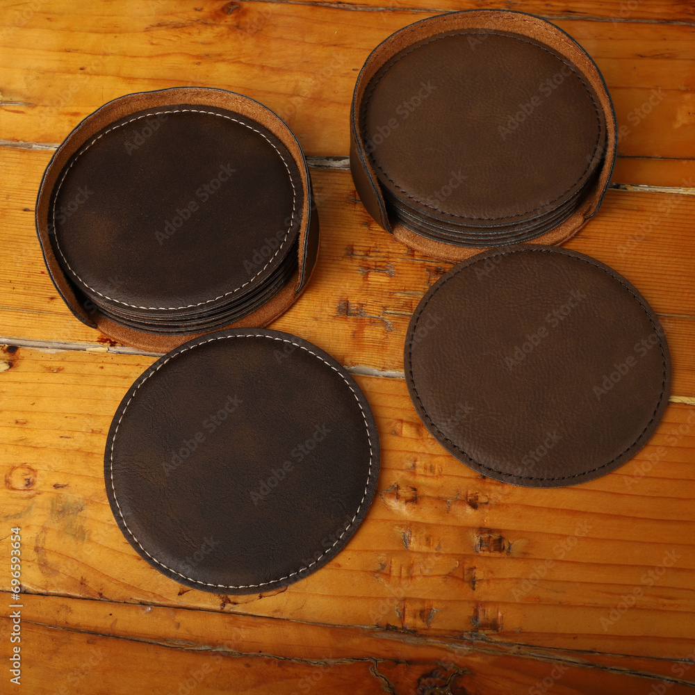Leather table mats in different colors. Concept shot, top view. Custom background view of leather table coaster. Stitched and leather table coaster Leather table mats in different colors. Concept shot, top view. Custom background view of leather table coaster. Stitched and leather table coaster
