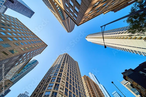 Upward view of Chicago skyscrapers stretching toward clear blue sky  architecture  travel  tourism
