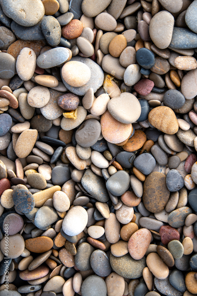 Natural Coastal Aesthetics: Flat Round Pebbles on the Beach Natural Coastal Aesthetics: Flat Round Pebbles on the Beach