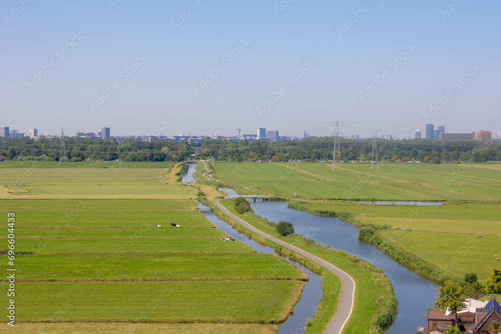 Typical Dutch polder in summer, Canal or ditch and green meadow, Overview from the top of Church tower in Ransdorp, A small village part of the municipality of Amsterdam, North Holland, Netherlands.