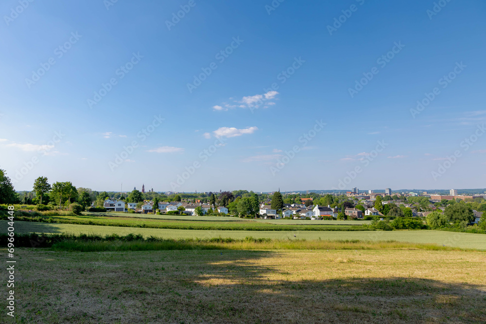 Summer landscape, The terrain of hilly countryside green grass meadow and farmland in Zuid-Limburg, Houses and church on hillside under blue sky, Maastricht is a capital city of Limburg, Netherlands.