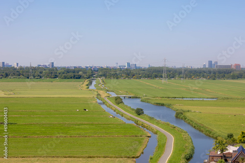 Fotografie Typical Dutch polder in summer, Canal or ditch and green meadow, Overview from the top of Church tower in Ransdorp, A small village part of the municipality of Amsterdam, North Holland, Netherlands