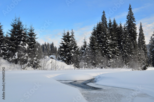 Winter landscape. Frozen river near Comandau village, Romania