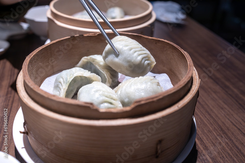 Chinese steamed dumplings in bamboo steamer, close up photo