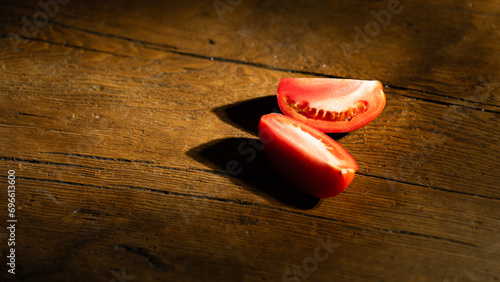 Sliced tomato on a wooden background. Selective focus. Toned.