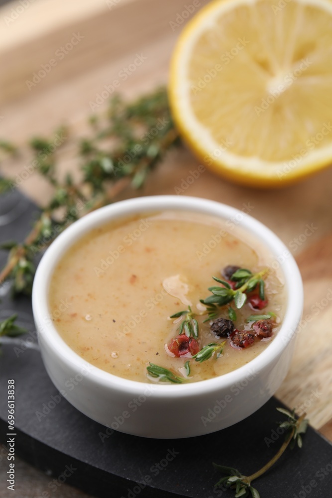 Delicious turkey gravy, thyme and peppercorns on board, closeup Delicious turkey gravy, thyme and peppercorns on board, closeup