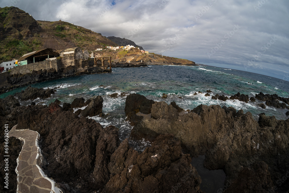 The rocky shore and natural pools of El Caleton. Garachico. Tenerife. Canary islands. Spain. Fisheye lens.