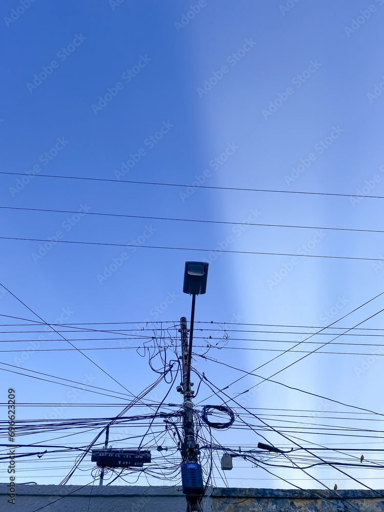 electricity post with blue sky background, closeup of photo.