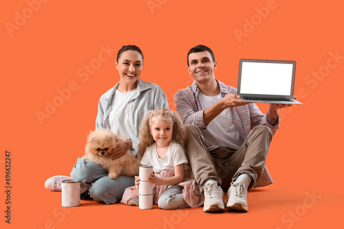 Happy family with laptop an...