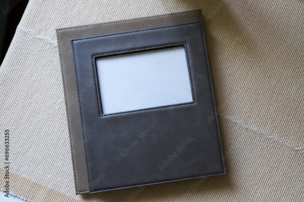 Leather photo frame in gray colors. Concept shot. Custom background, Creative composition of modern living room interior. Free space for text and picture or photograph . Stylish accessory for home. Leather photo frame in gray colors. Concept shot. Custom background, Creative composition of modern living room interior. Free space for text and picture or photograph . Stylish accessory for home.