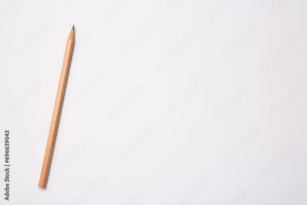 Sharp graphite pencil on white background, top view. Space for text Sharp graphite pencil on white background, top view. Space for text