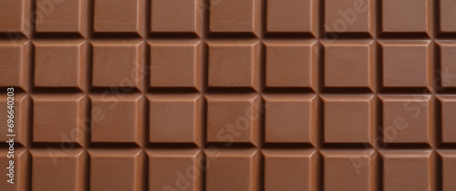 Delicious milk chocolate bar as background, closeup. Banner design