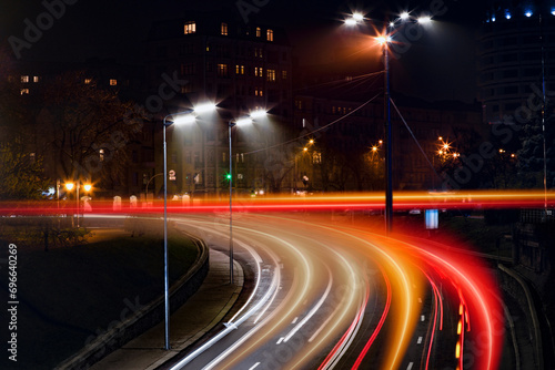 Road traffic, motion blur effect. View of night cityscape with car light trails