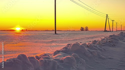 Beautiful red and orange sunrise in a remote snowy outdoor landscape photo