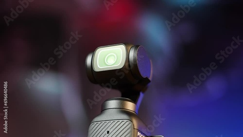 Close up of small pocket size electronic camera with gimbal stabilization photo