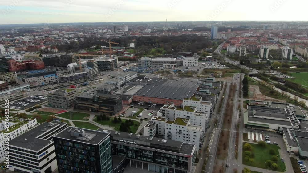 Drone view in Malmö, Sweden. Flying over the port with modern style buildings, parks and the sea on the horizon Drone view in Malmö, Sweden. Flying over the port with modern style buildings, parks and the sea on the horizon