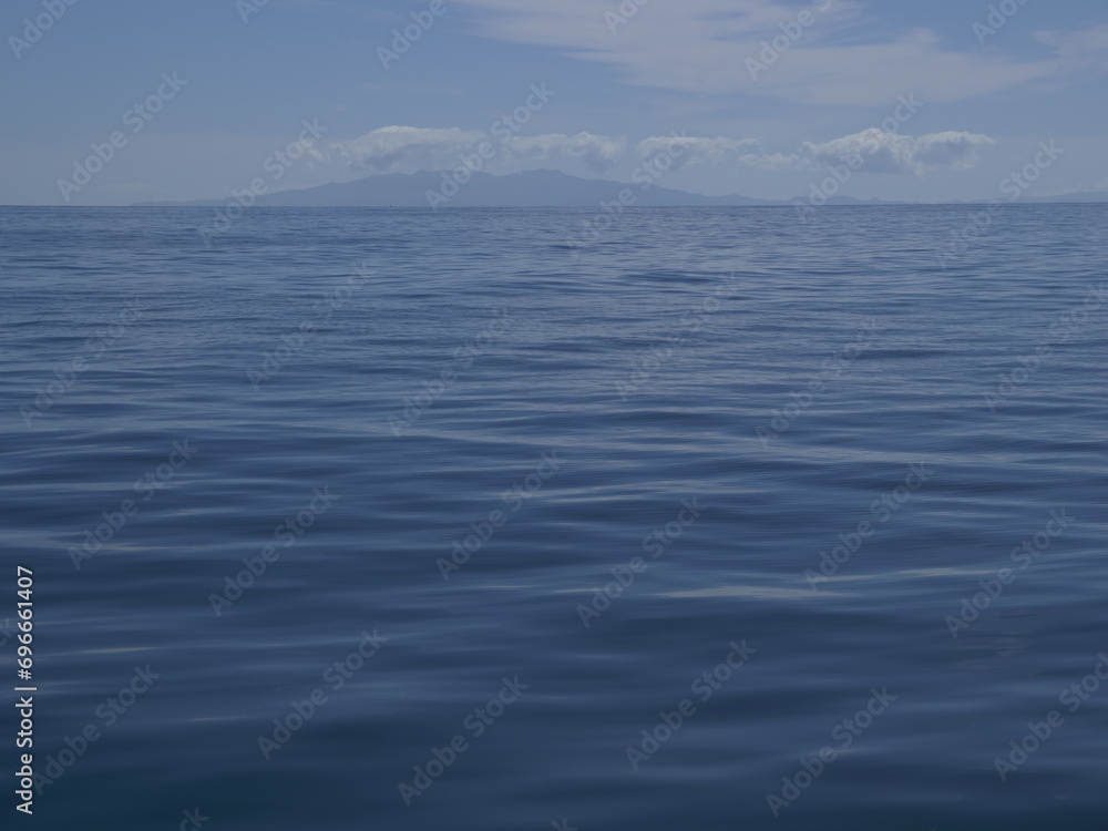 Sailing on calm waters of Hauraki Gulf towards Coromandel Peninsula in distance. Location: Auckland New Zealand Sailing on calm waters of Hauraki Gulf towards Coromandel Peninsula in distance. Location: Auckland New Zealand