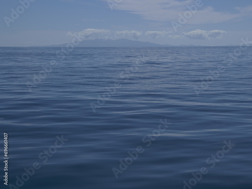 Sailing on calm waters of Hauraki Gulf towards Coromandel Peninsula in distance. Location: Auckland New Zealand