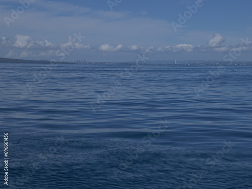 Sailing on calm waters of Hauraki Gulf towards Auckland CBD. Location: Auckland New Zealand