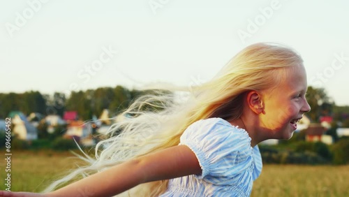 Cute girly blonde with long hair runs photo