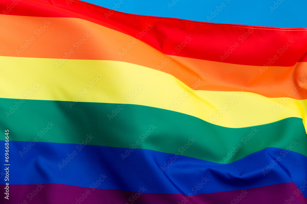Fototapeta premium Rainbow flag waving on blue background