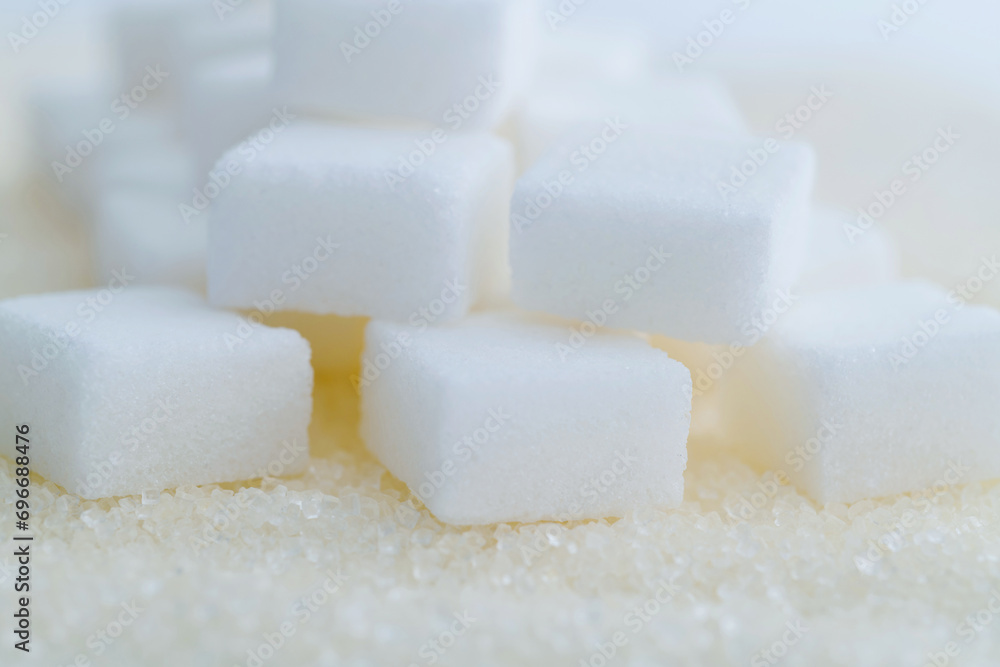 Sugar cubes on top of granulated sugar Sugar cubes on top of granulated sugar