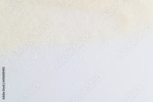 White sugar crystals on white background photo