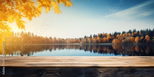 Wooden table with waterside retreat. Immerse in breathtaking beauty of nature serene lakeside haven. Sun sets or rises warm rays paint sky with spectrum of colors casting golden glow over landscape photo