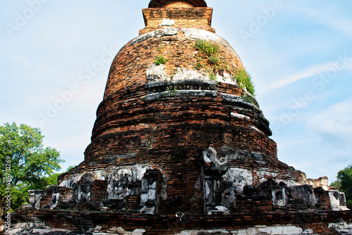 Ancient ruins ubosot ordination hall and antique old ruin stupa chedi for thai people traveler travel visit respect myth mystical in Wat Maheyong temple at Historic Heritage site in Ayutthaya Thailand photo