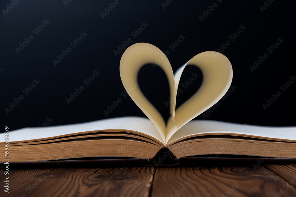 Book pages curved into heart shape Book pages curved into heart shape